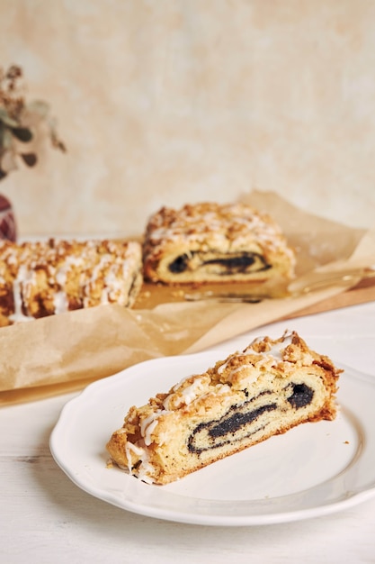 Selective focus shot of delicious poppy seeds piece of cake with a white sugar glaze