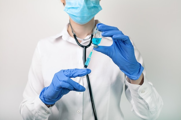 Selective focus shot of a doctor holding a syringe with vaccination