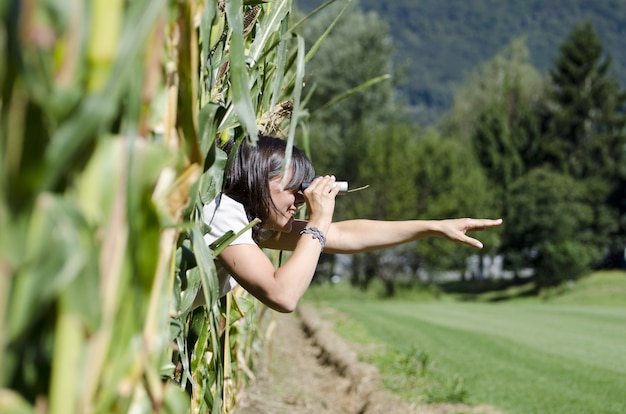 Free photo selective focus shot of female looking through binoculars from a window