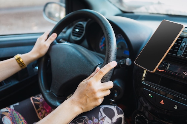 Selective focus shot of female's hands driving a car