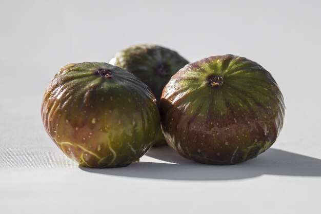 Selective focus shot of figs isolated on white table