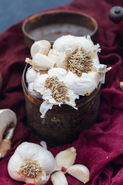 Selective focus shot of garlic placed in a rusty can