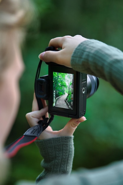 Selective focus shot of a girl using a professional camera