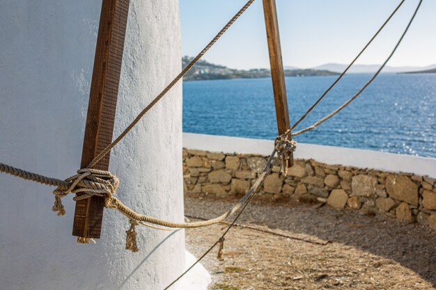 Selective focus shot of a lower part of a tower at the ocean in Mykonos, Greece