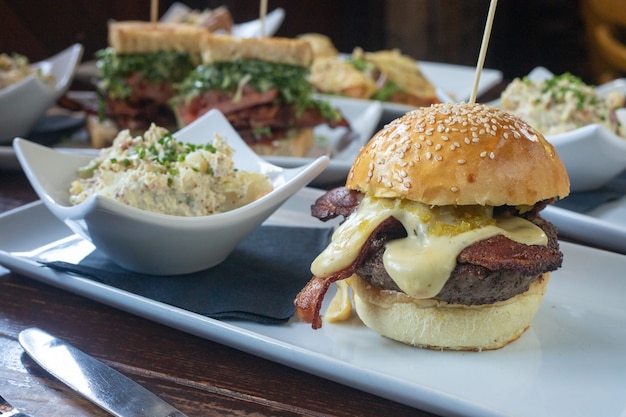 Selective focus shot of a steam-grilled sandwich with melted cheese and salad on the side