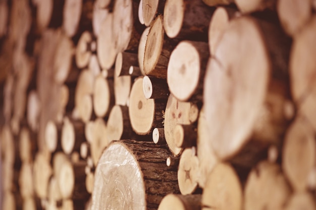 Selective focus of stacked tree lumber under the lights 