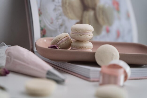 Selective of macaroons on a table with cream