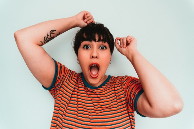 Self-portrait of a caucasian female with an exciting and shocked facial expression