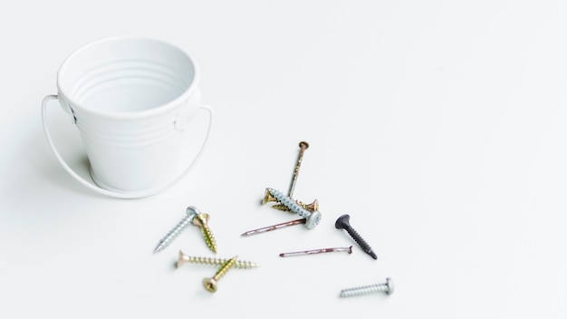 Free photo self-tapping screws and nails near small bucket