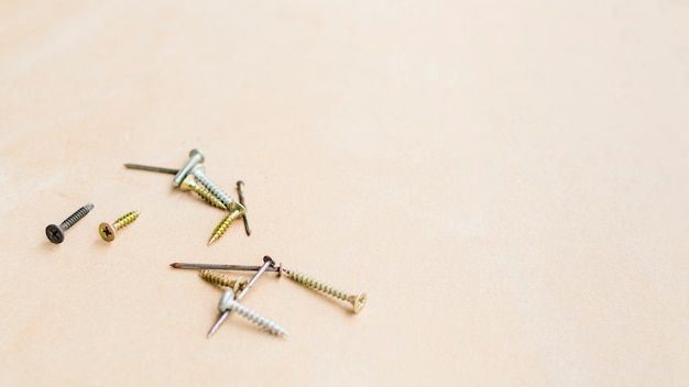 Free photo self-tapping screws and rusty nails on table