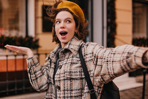 Selfie of funny woman student in checkered coat