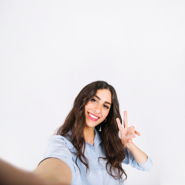 Selfie of woman making peace sign