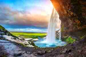 Free photo seljalandsfoss waterfall during the sunset, beautiful waterfall in iceland.