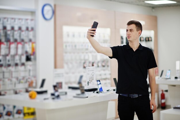 Seller man mobile phone professional consultant in tech store or shop