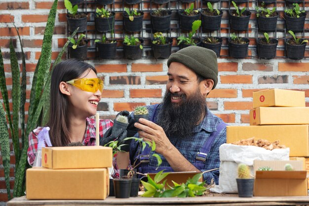 Selling plant online; couples smiling while growing plants