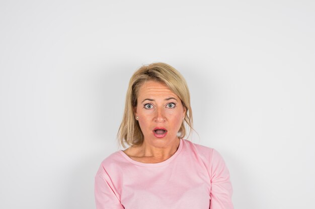 Senior amazed woman in rose blouse