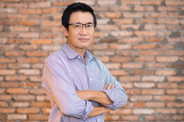 Senior Asian Man Standing with Arms Crossed