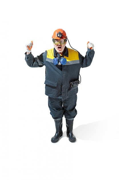 senior bearded male miner standing at the camera on a white