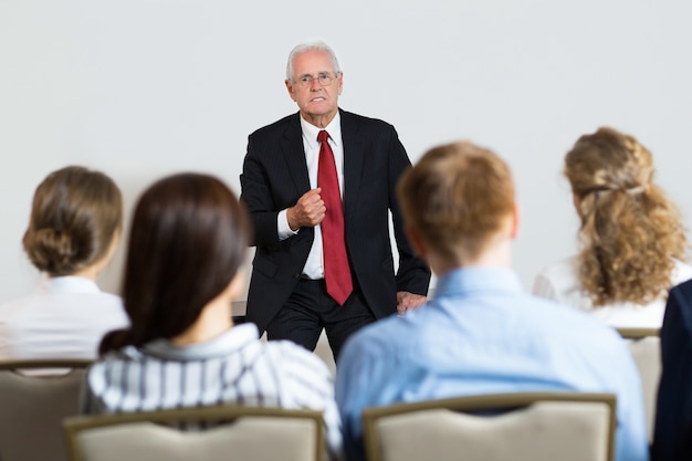 Senior business man giving a lecture