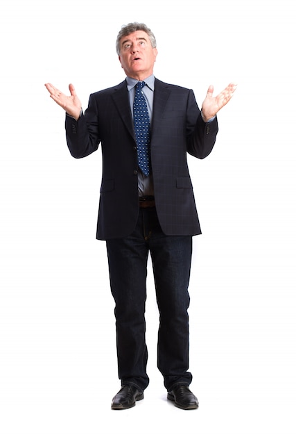 Senior businessman looking up with open hands