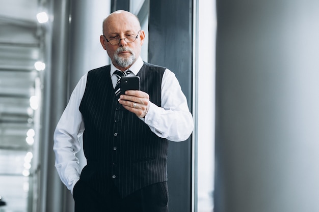 Senior businessman talking on the phone at the office