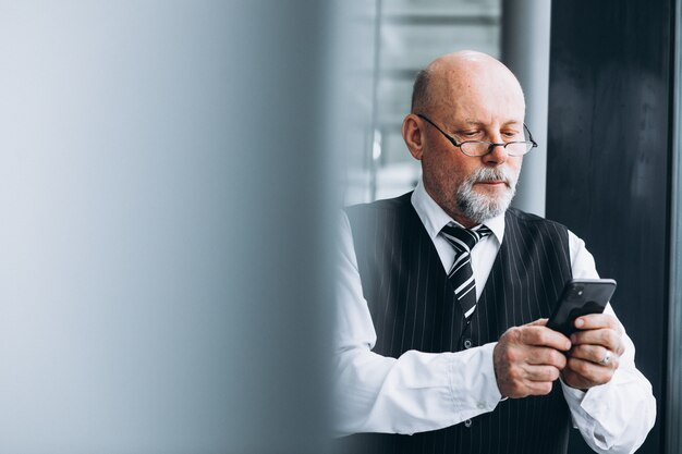 Senior businessman talking on the phone at the office