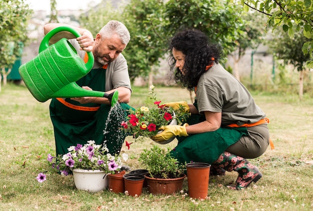 Senior couple caring the flowers