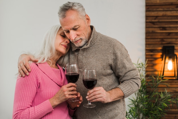 Senior couple celebrating valentines day with wine