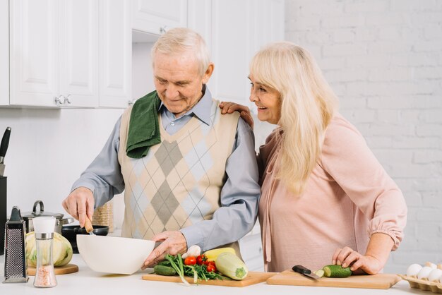 Senior couple cooking in kitchen