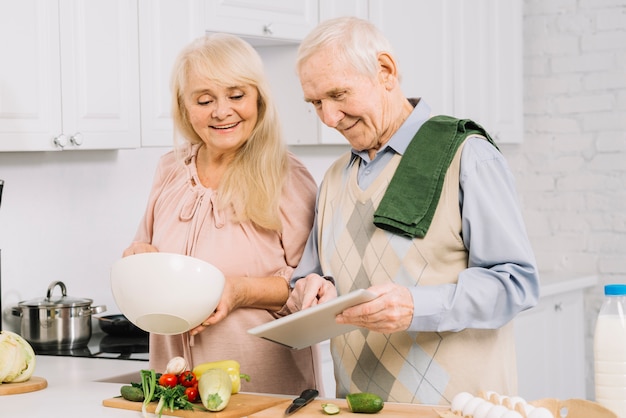 Senior couple cooking in kitchen