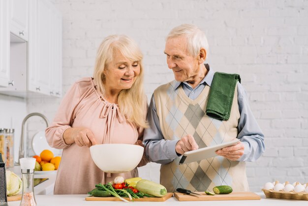 Senior couple cooking in kitchen