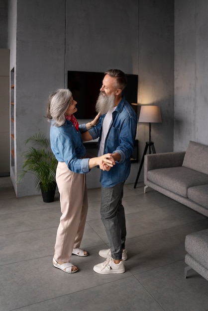 Senior couple dancing at home