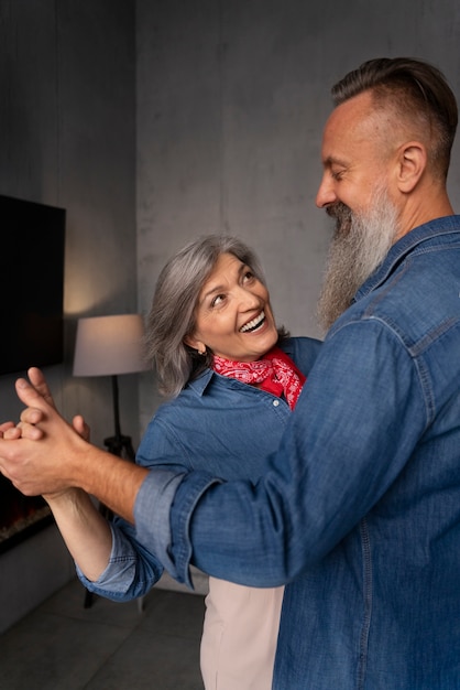 Senior couple dancing at home