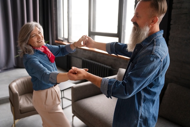 Senior couple dancing at home