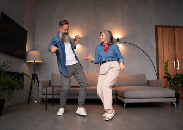 Senior couple dancing at home