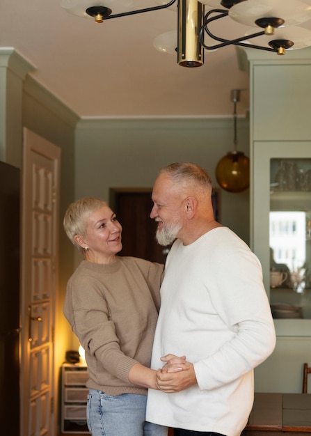 Senior couple dancing at home