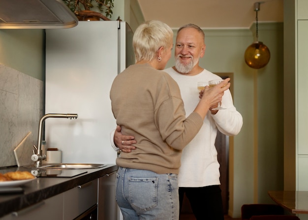 Free photo senior couple dancing at home