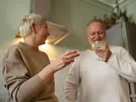 Free photo senior couple dancing at home