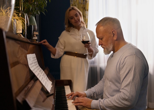 Free photo senior couple dancing at home