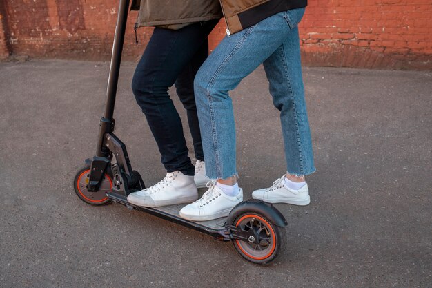 Senior couple on electric scooter side view