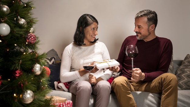 Senior couple exchanging christmas gifts