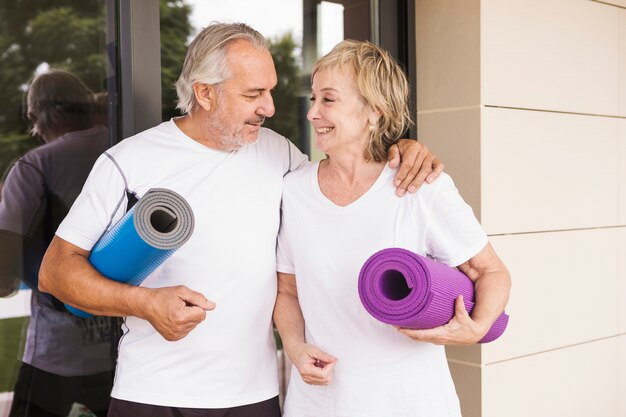 Senior couple excising in garden