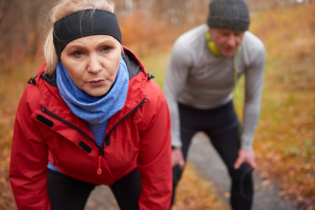 Senior couple exercising in the autumnal forest