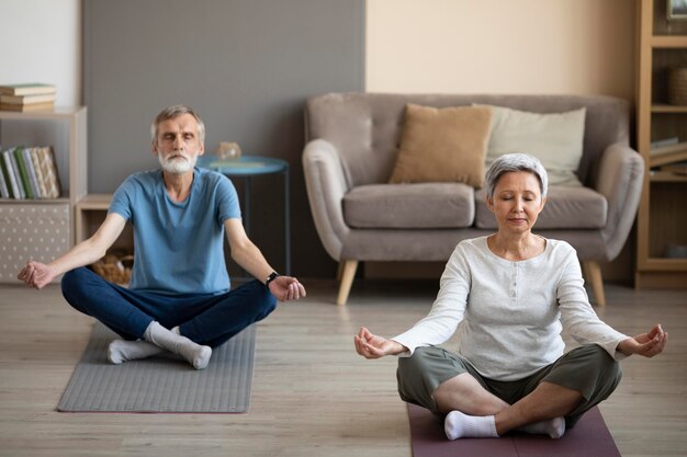 Senior couple exercising together at home