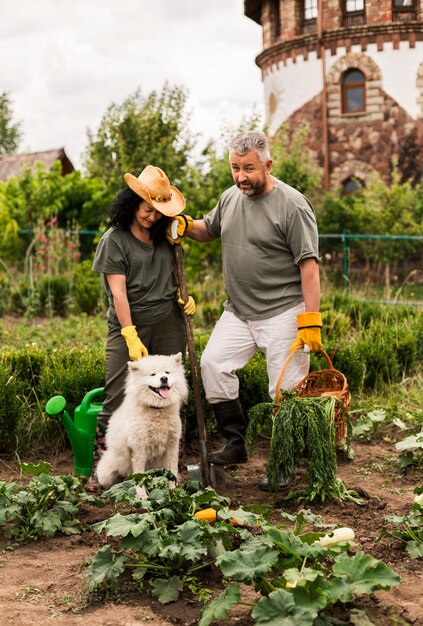 Senior couple in garden with a dog