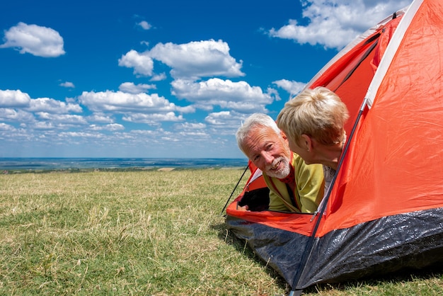 Senior couple having rest, in the tent