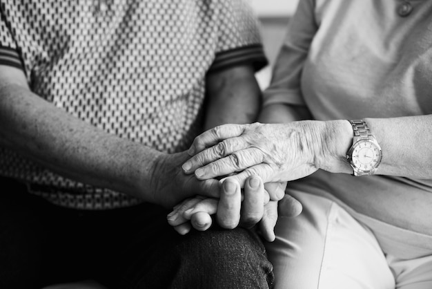 Senior couple holding hands together