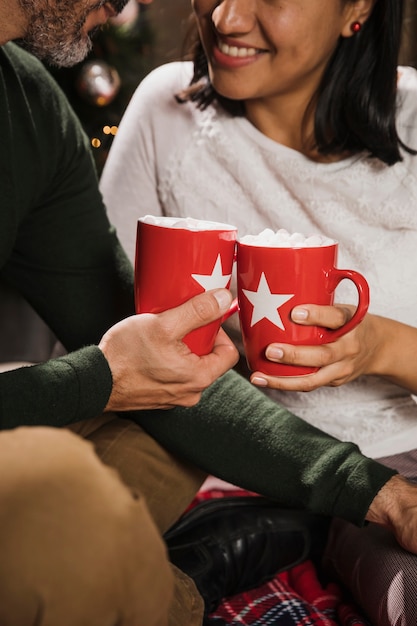 Senior couple holding warm mugs