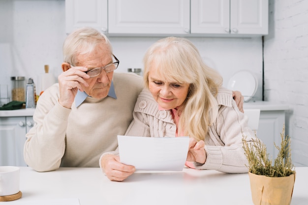 Senior couple looking at paper