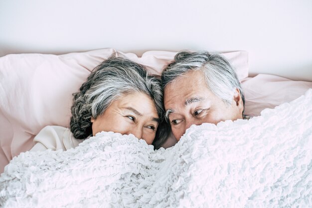 Senior couple lying in bed together